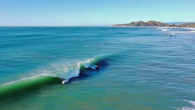 Surfing at Wainui Beach in Gisborne